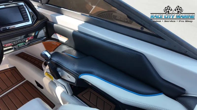 Slide: The Image of The image shows the cockpit of a 2015 Nautique G23 with modern controls and a display. - 48