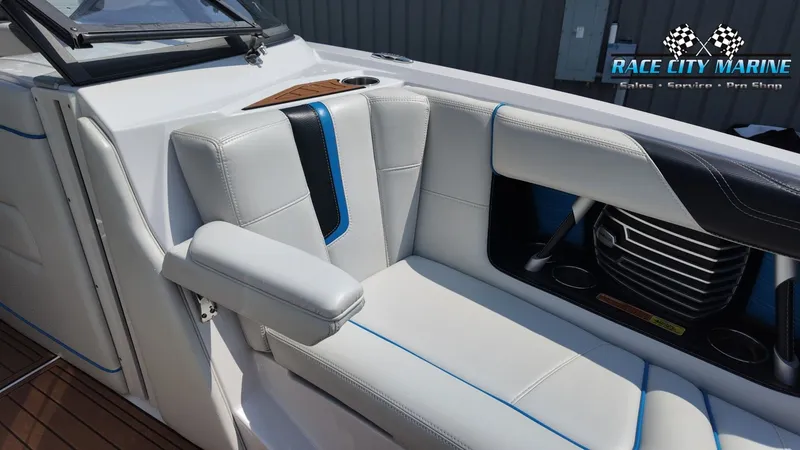 Slide: The Image of The image shows the interior of a 2015 Nautique G23 with white upholstery and blue accents. - 15
