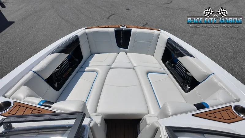 Slide: The Image of The image shows the bow area of a 2015 Nautique G23 boat with white upholstery. - 37