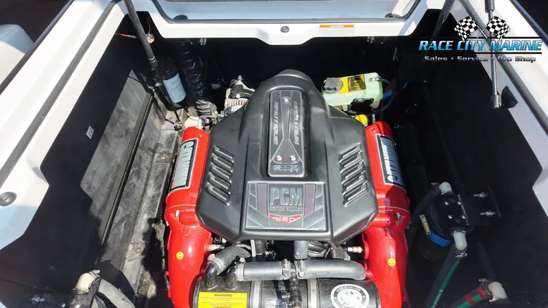 Slide: The Image of The engine compartment of a 2015 Nautique G23 boat features a powerful PCM engine with red accents. - 11