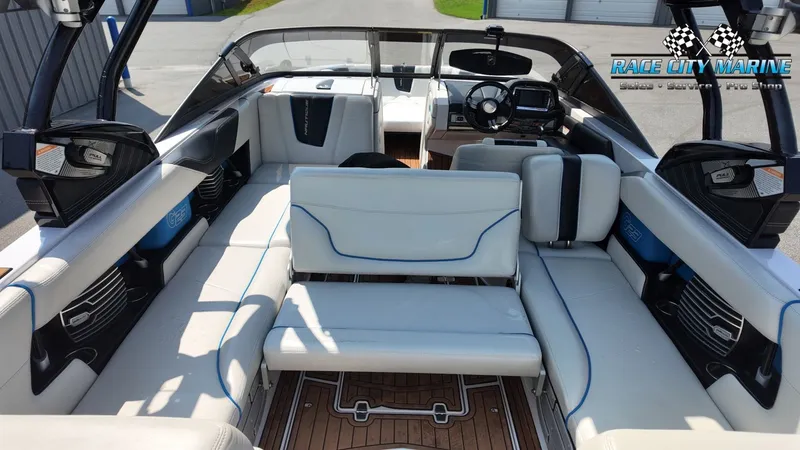 Slide: The Image of The image shows the interior of a 2015 Nautique G23 boat with white leather seating and a modern cockpit. - 43