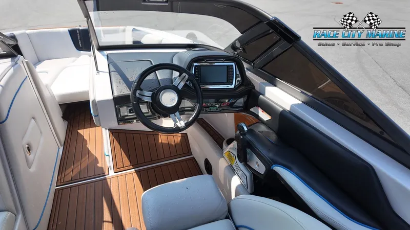 Slide: The Image of The image shows the cockpit of a 2015 Nautique G23 boat with a modern helm. - 50