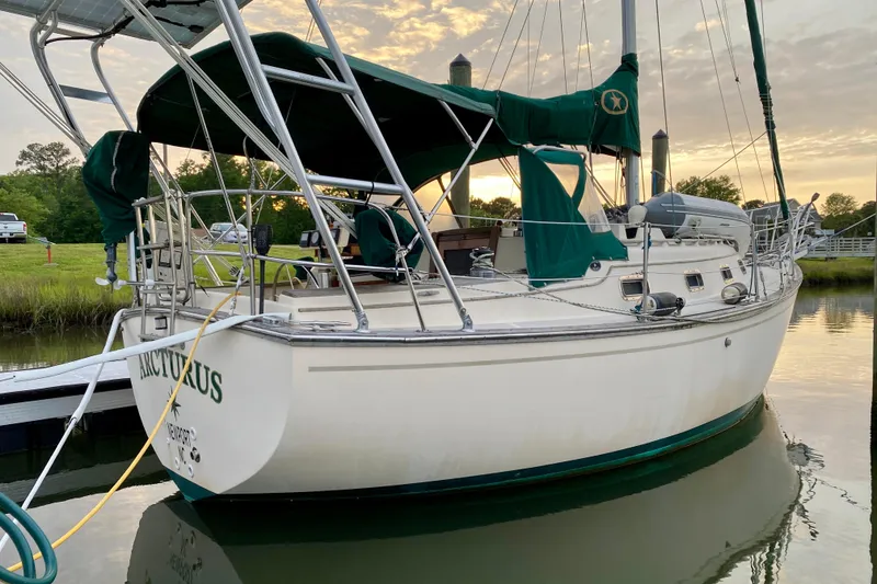 Slide: The Image of Sailboat Island Packet 29, 1992 model, docked at sunset with green canopy. - 10