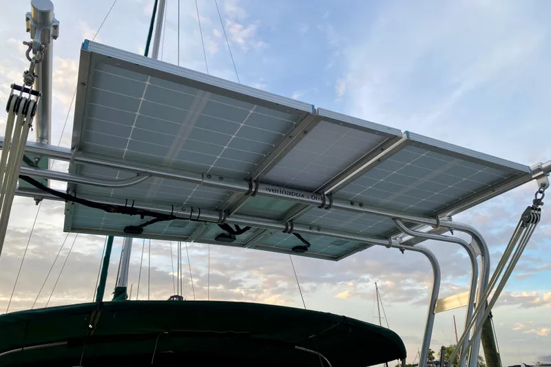 Slide: The Image of Solar panels mounted on a 1992 Island Packet 29 sailboat under a clear sky. - 15