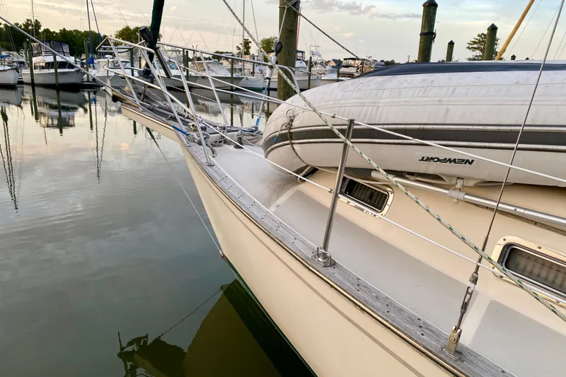 Slide: The Image of 1992 Island Packet 29 sailboat docked with inflatable dinghy on deck. - 22