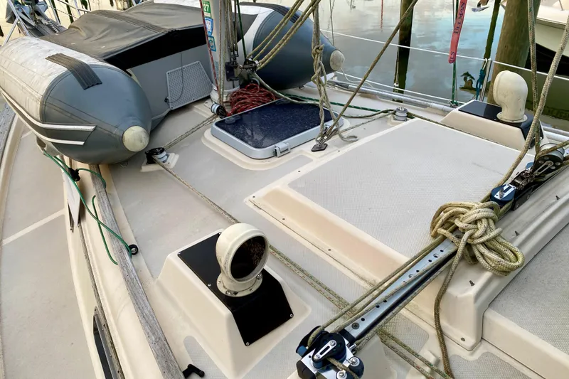 Slide: The Image of Deck of 1992 Island Packet 29 sailboat with ropes and inflatable dinghy. - 24