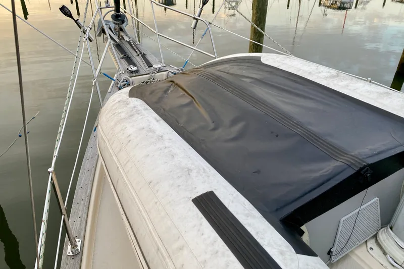 Slide: The Image of Sailboat deck of 1992 Island Packet 29 with black cover and rigging details. - 25