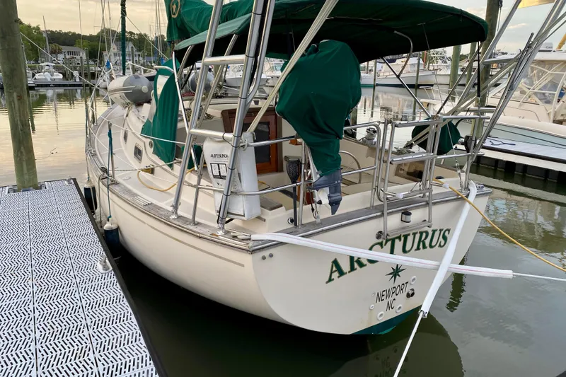Slide: The Image of 1992 Island Packet 29 sailboat docked, featuring green covers and Newport, NC registration. - 3