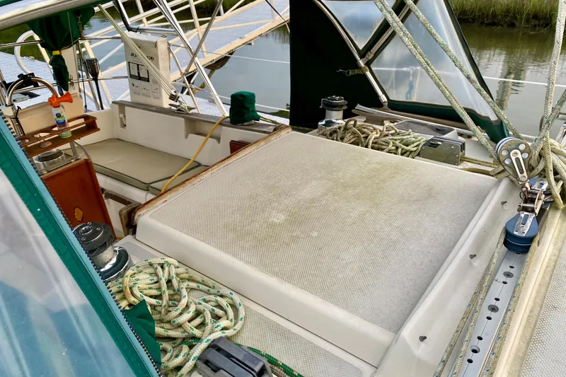 Slide: The Image of Cockpit of 1992 Island Packet 29 sailboat with ropes and seating area. - 30