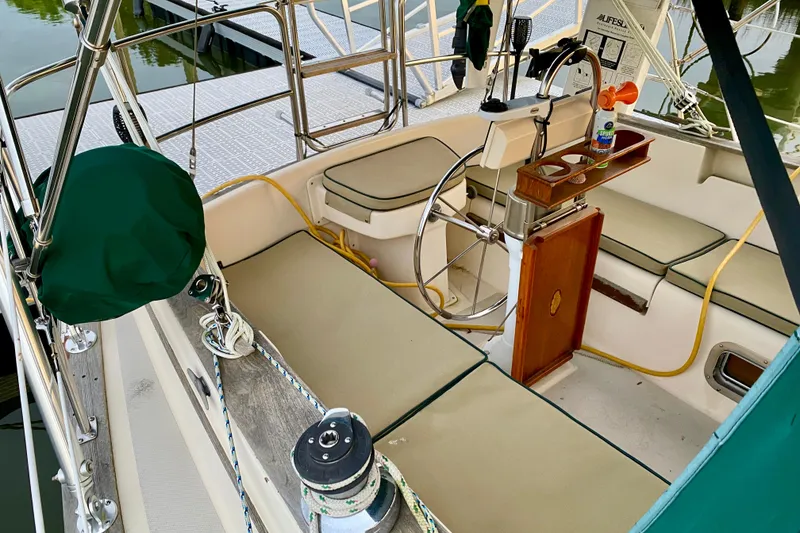 Slide: The Image of Cockpit of 1992 Island Packet 29 sailboat with steering wheel and seating. - 31
