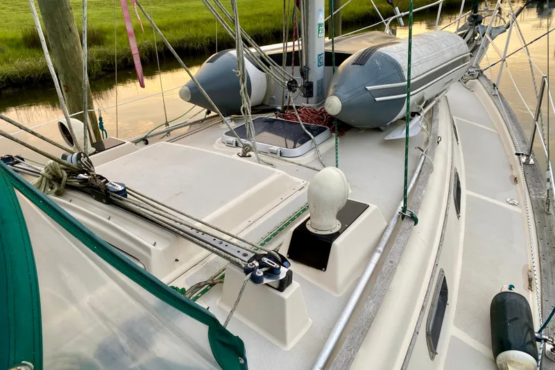 Slide: The Image of 1992 Island Packet 29 sailboat deck with rigging and inflatable dinghy. - 34