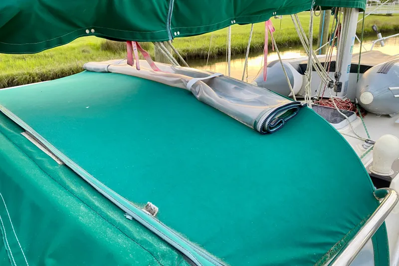 Slide: The Image of Green canvas cover on 1992 Island Packet 29 sailboat deck. - 35