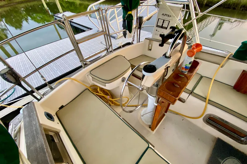Slide: The Image of Cockpit of 1992 Island Packet 29 sailboat with steering wheel and seating. - 36