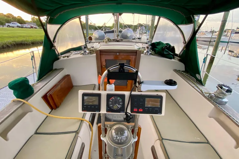 Slide: The Image of Cockpit of a 1992 Island Packet 29 sailboat with green canopy and navigation instruments. - 37