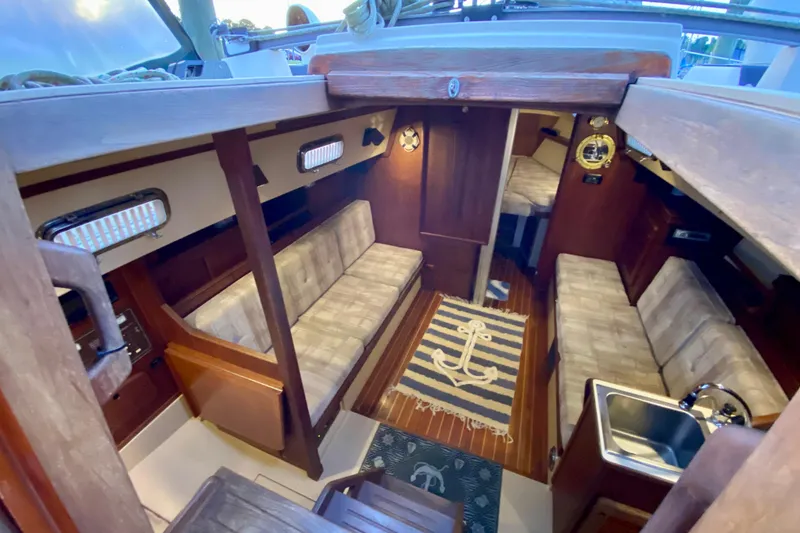 Slide: The Image of Interior of a 1992 Island Packet 29 sailboat with cozy seating and nautical decor. - 44