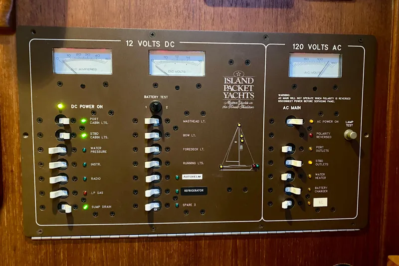 Slide: The Image of Electrical control panel of a 1992 Island Packet 29 yacht, showing 12V DC and 120V AC systems. - 52