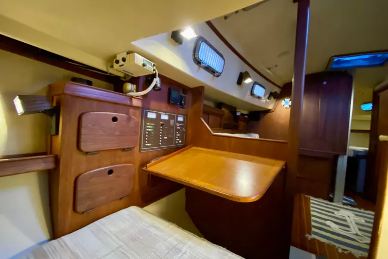 Slide: The Image of 1992 Island Packet 29 yacht interior with wooden cabinetry and navigation panel. - 57