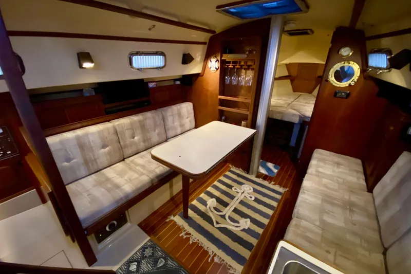 Slide: The Image of Interior of 1992 Island Packet 29 sailboat with cozy seating and nautical decor. - 59