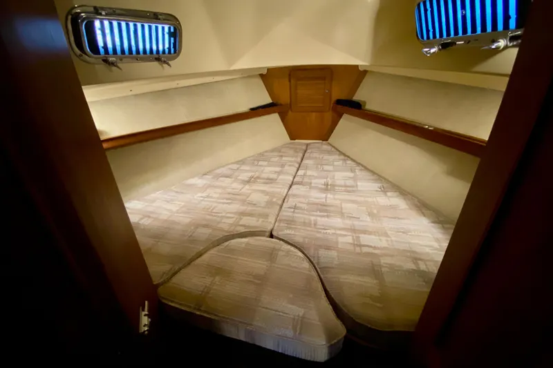Slide: The Image of Interior cabin of a 1992 Island Packet 29 sailboat, featuring a cozy V-berth. - 67