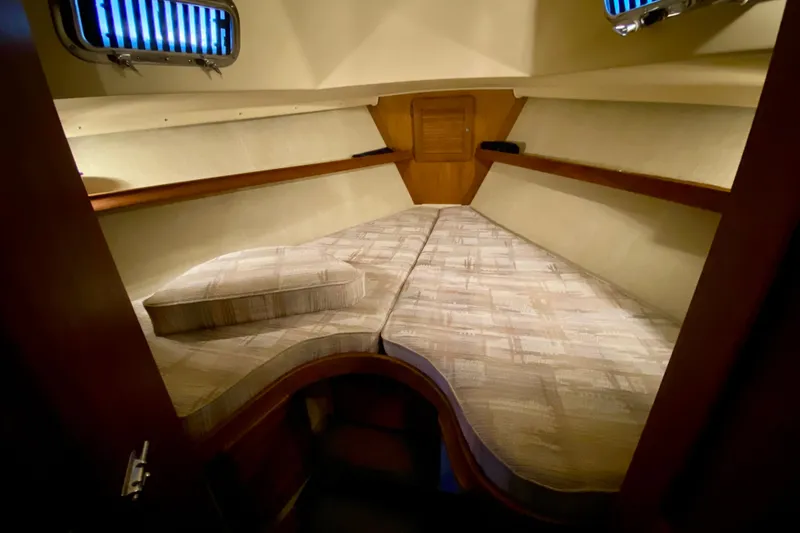 Slide: The Image of Cozy cabin interior of a 1992 Island Packet 29 sailboat with cushioned V-berth. - 68
