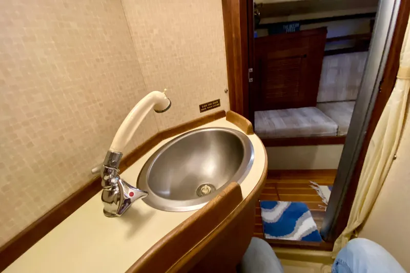 Slide: The Image of 1992 Island Packet 29 yacht interior with sink and cozy cabin view. - 77