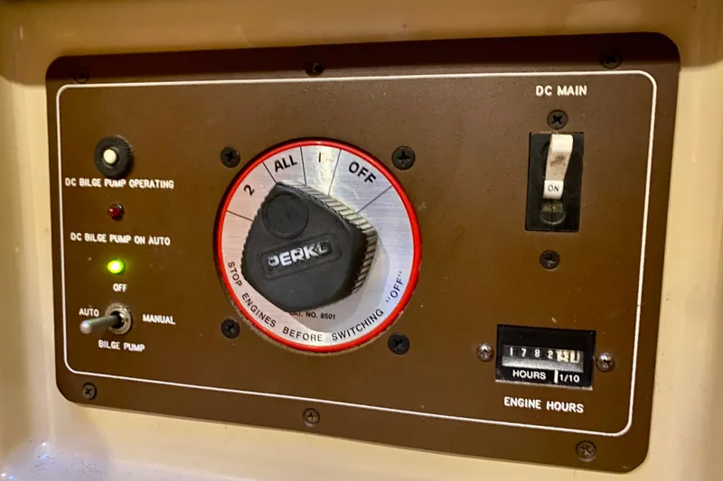 Slide: The Image of Control panel of a 1992 Island Packet 29 sailboat with bilge pump and engine hours display. - 85
