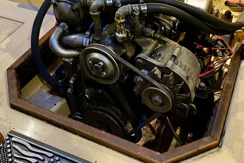 Slide: The Image of Engine compartment of a 1992 Island Packet 29 sailboat, showcasing mechanical components. - 87