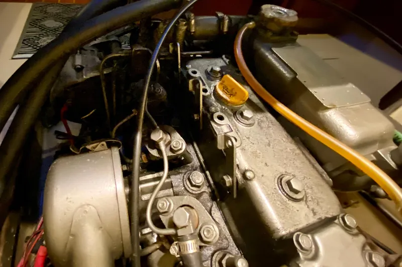 Slide: The Image of Engine of a 1992 Island Packet 29 sailboat, showcasing mechanical components and hoses. - 91