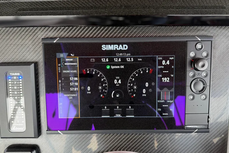 Slide: The Image of Simrad display on 2022 Fountain 34 SC boat dashboard showing engine and navigation data. - 10