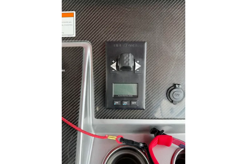 Slide: The Image of Control panel on 2022 Fountain 34 SC boat dashboard with carbon fiber finish. - 12