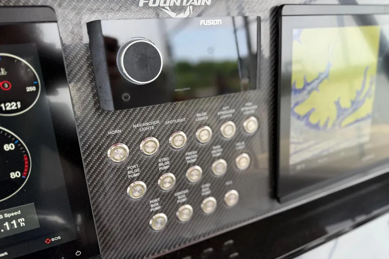 Slide: The Image of Control panel of 2022 Fountain 34 SC boat with navigation and system controls. - 16