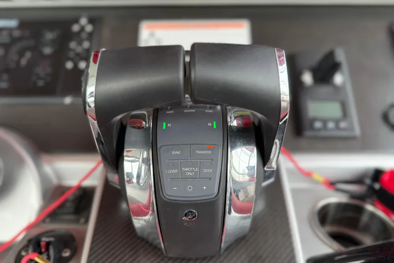 Slide: The Image of Throttle controls on a 2022 Fountain 34 SC boat dashboard. - 18