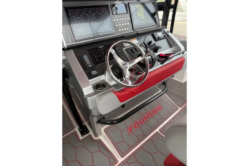 Slide: The Image of 2022 Fountain 34 SC boat dashboard with steering wheel and navigation controls. - 20