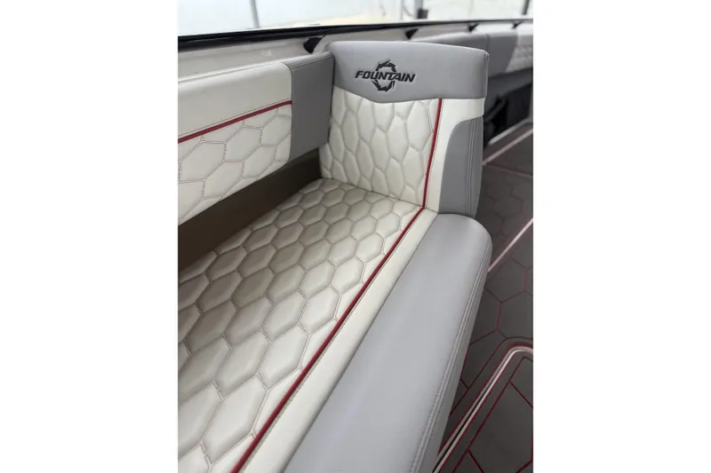 Slide: The Image of Luxurious seating in 2022 Fountain 34 SC boat with hexagonal pattern and logo. - 22