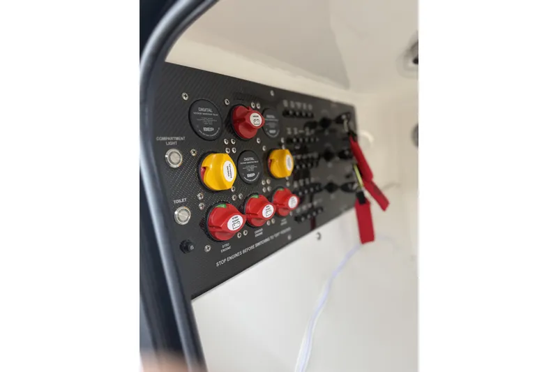 Slide: The Image of Control panel of 2022 Fountain 34 SC boat with switches and indicators. - 23
