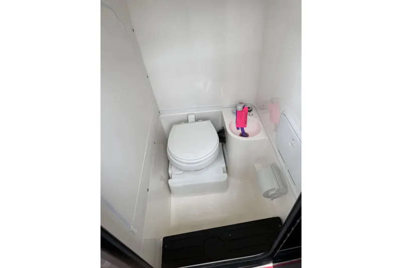Slide: The Image of 2022 Fountain 34 SC boat bathroom interior with toilet and sink. - 25