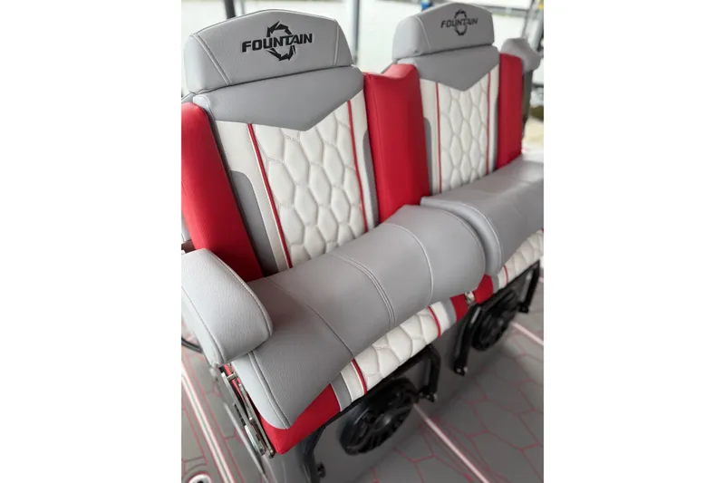 Slide: The Image of Red and gray seating on 2022 Fountain 34 SC boat, featuring quilted design and logo. - 26
