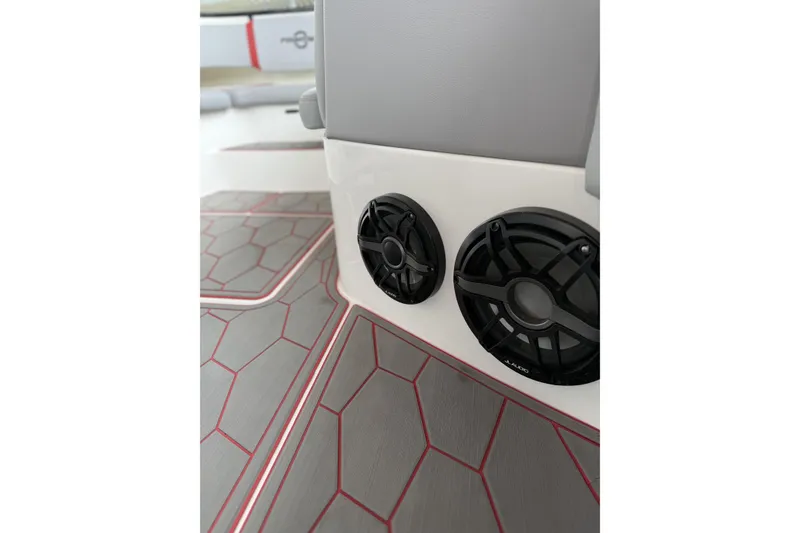 Slide: The Image of 2022 Fountain 34 SC boat interior with speakers and geometric flooring design. - 28