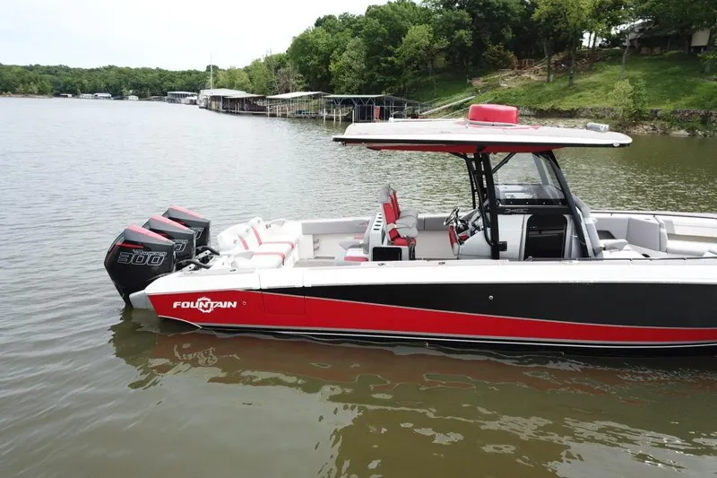 Slide: The Image of 2022 Fountain 34 SC boat with triple engines on a calm lake. - 3