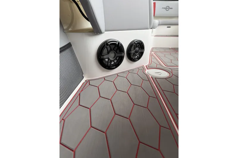 Slide: The Image of 2022 Fountain 34 SC boat interior with hexagonal patterned flooring and dual speakers. - 31