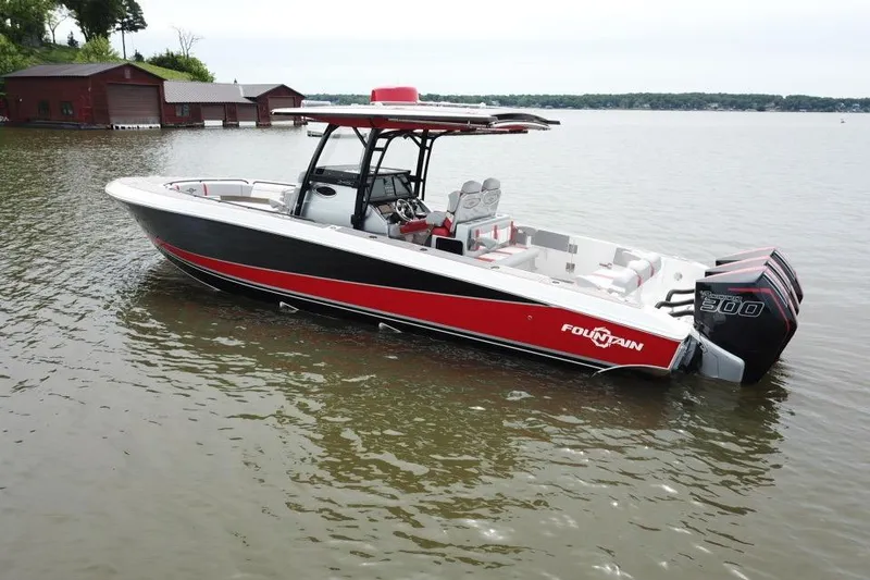 Slide: The Image of 2022 Fountain 34 SC boat with red and black design on calm water. - 4