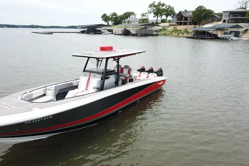 Slide: The Image of 2022 Fountain 34 SC boat on a lake near docks and houses. - 5