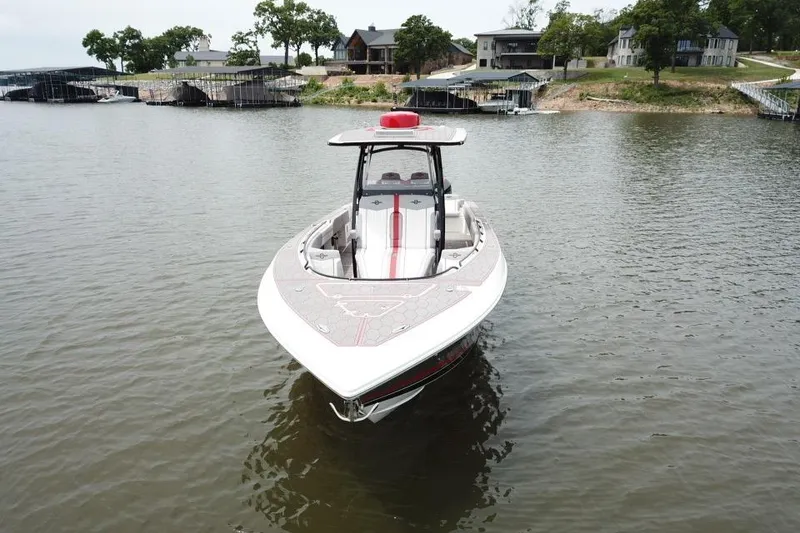 Slide: The Image of 2022 Fountain 34 SC boat on a lake near docks and houses. - 6