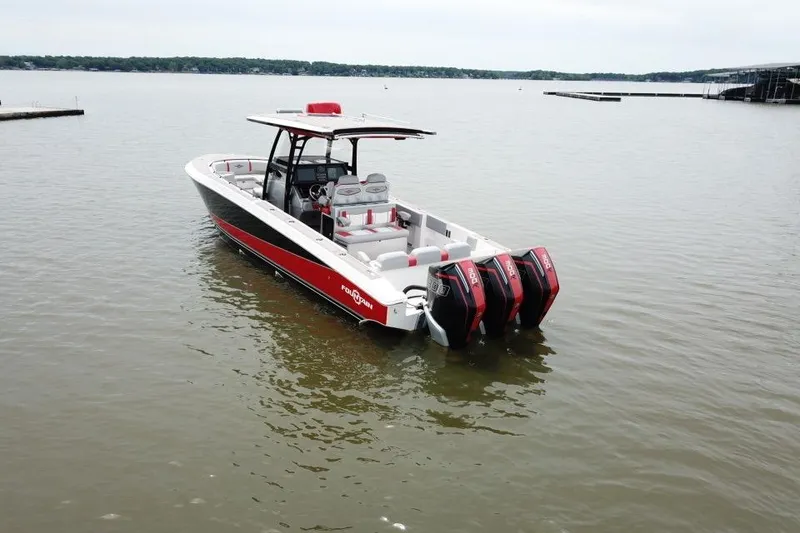 Slide: The Image of 2022 Fountain 34 SC boat with triple engines on a calm lake. - 7