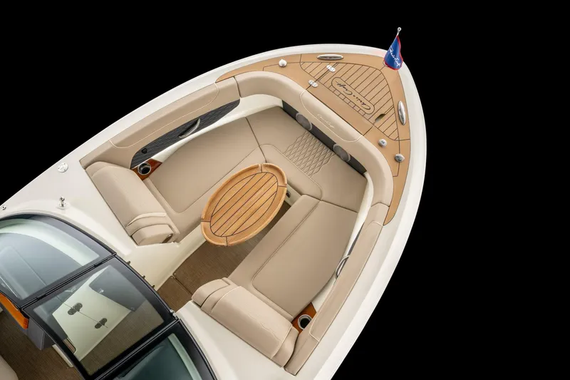 Slide: The Image of 2026 Chris-Craft Sportster 28 boat interior with elegant seating and wooden table. - 12
