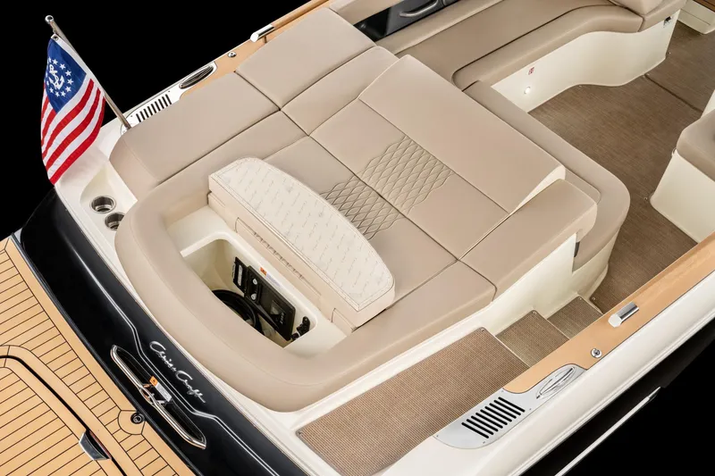 Slide: The Image of 2026 Chris-Craft Sportster 28 boat interior with beige seating and American flag. - 2