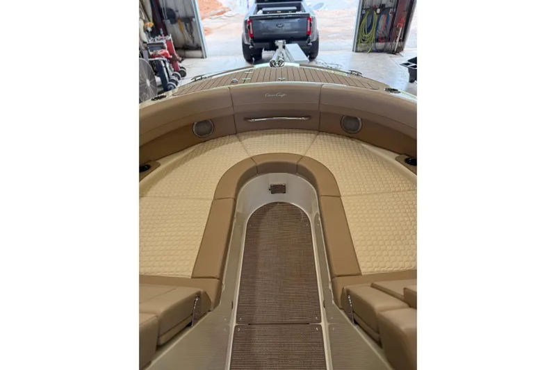 Slide: The Image of 2026 Chris-Craft Launch 31 GT interior with tan upholstery in a garage setting. - 13