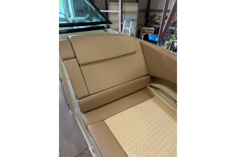 Slide: The Image of 2026 Chris-Craft Launch 31 GT interior with tan leather seating in a workshop setting. - 15