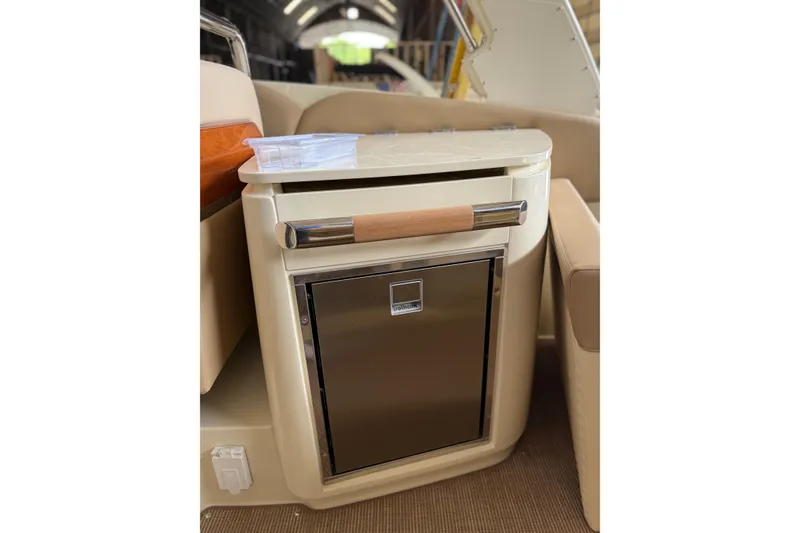 Slide: The Image of 2026 Chris-Craft Launch 31 GT interior detail with built-in stainless steel fridge. - 16