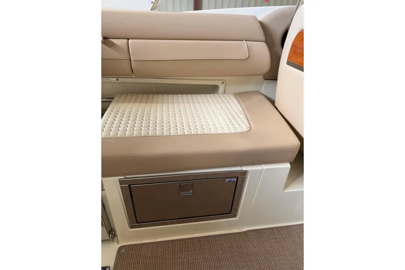 Slide: The Image of 2026 Chris-Craft Launch 31 GT interior seating with quilted cushion and storage compartment. - 17